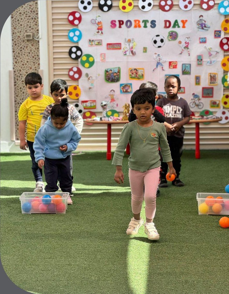 Children playing with colourful balls in the outdoor play area